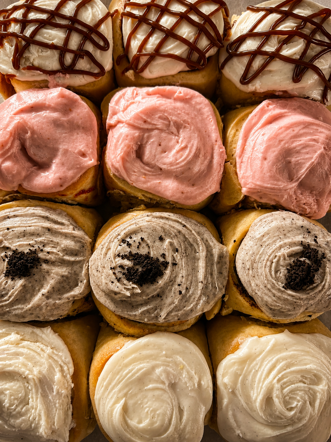 Tray of freshly frosted cinnamon rolls at the market