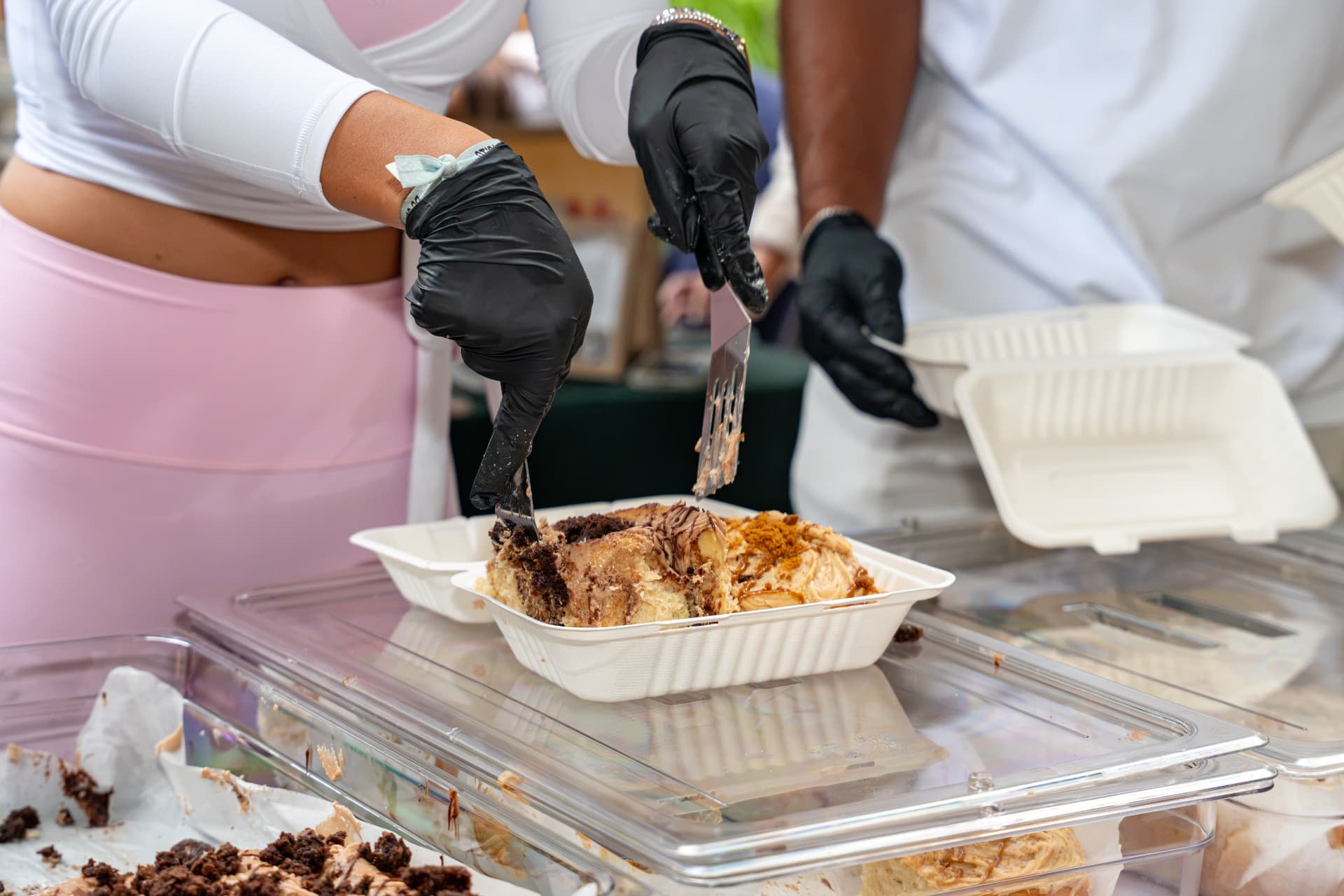 Team boxing up frosted cinnamon rolls at the market