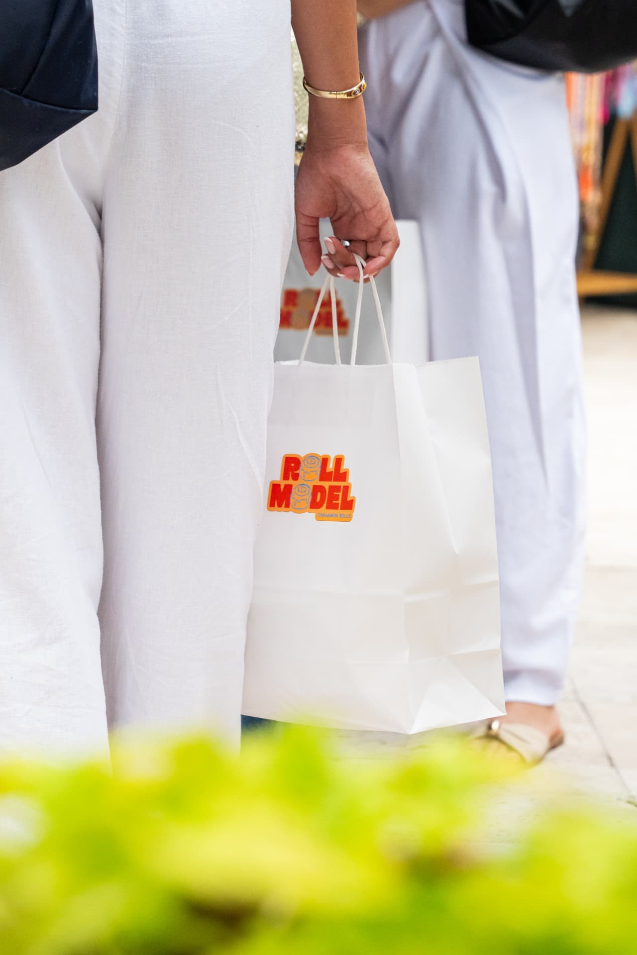 Customer carrying a Roll Model bag at the farmers market